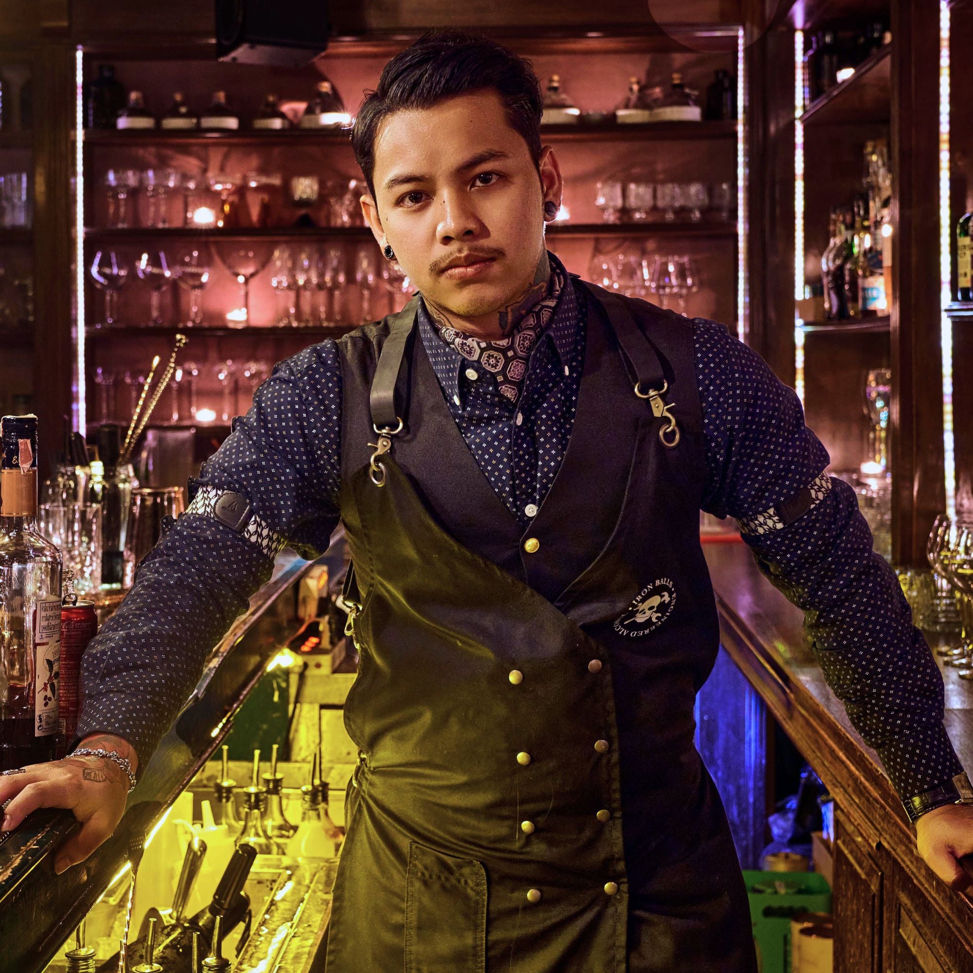 Bartender standing behind bar, wearing Wiseguy Original Sleeve Garters.