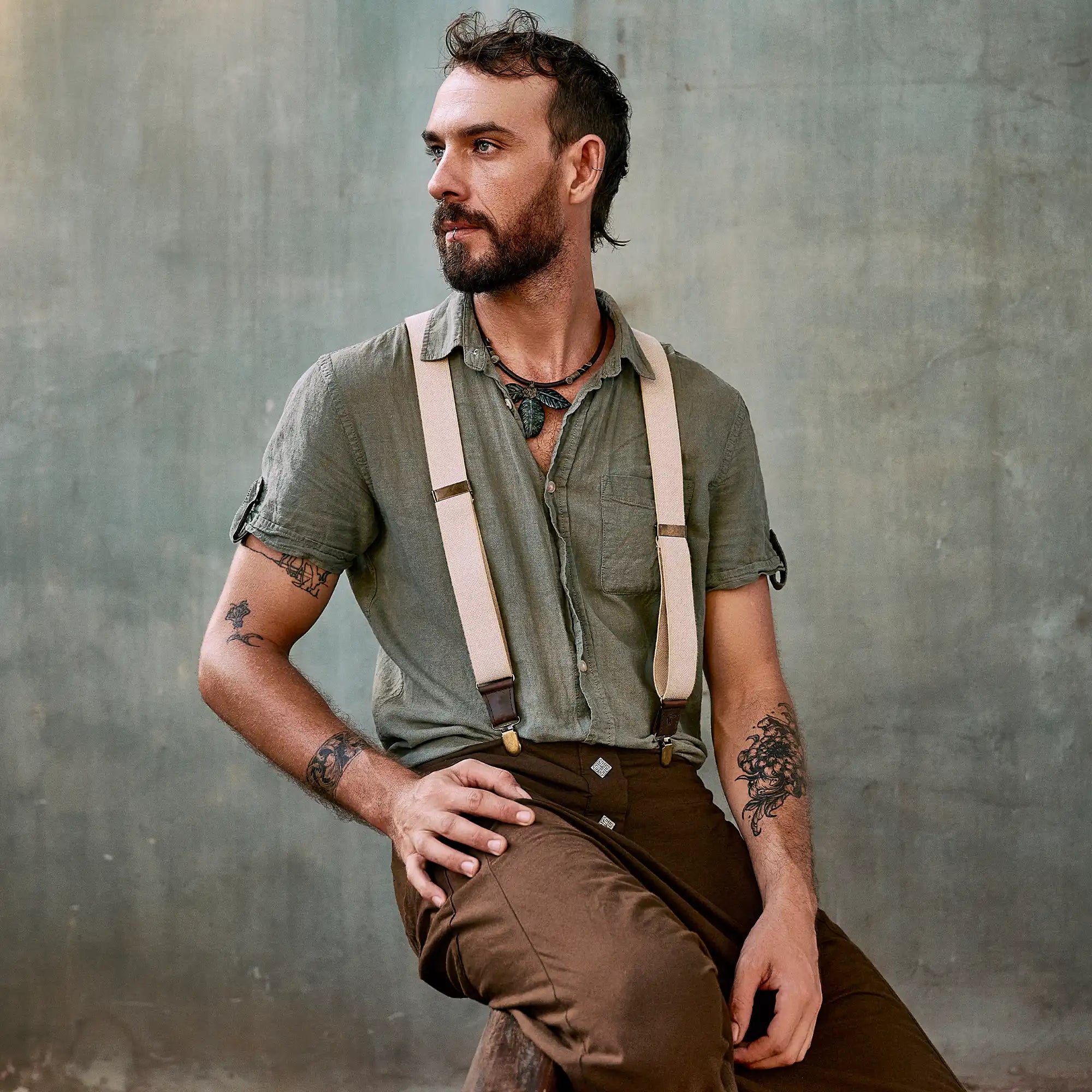 Bearded man with button shirt and Wiseguy Original Suspenders posing for photo.