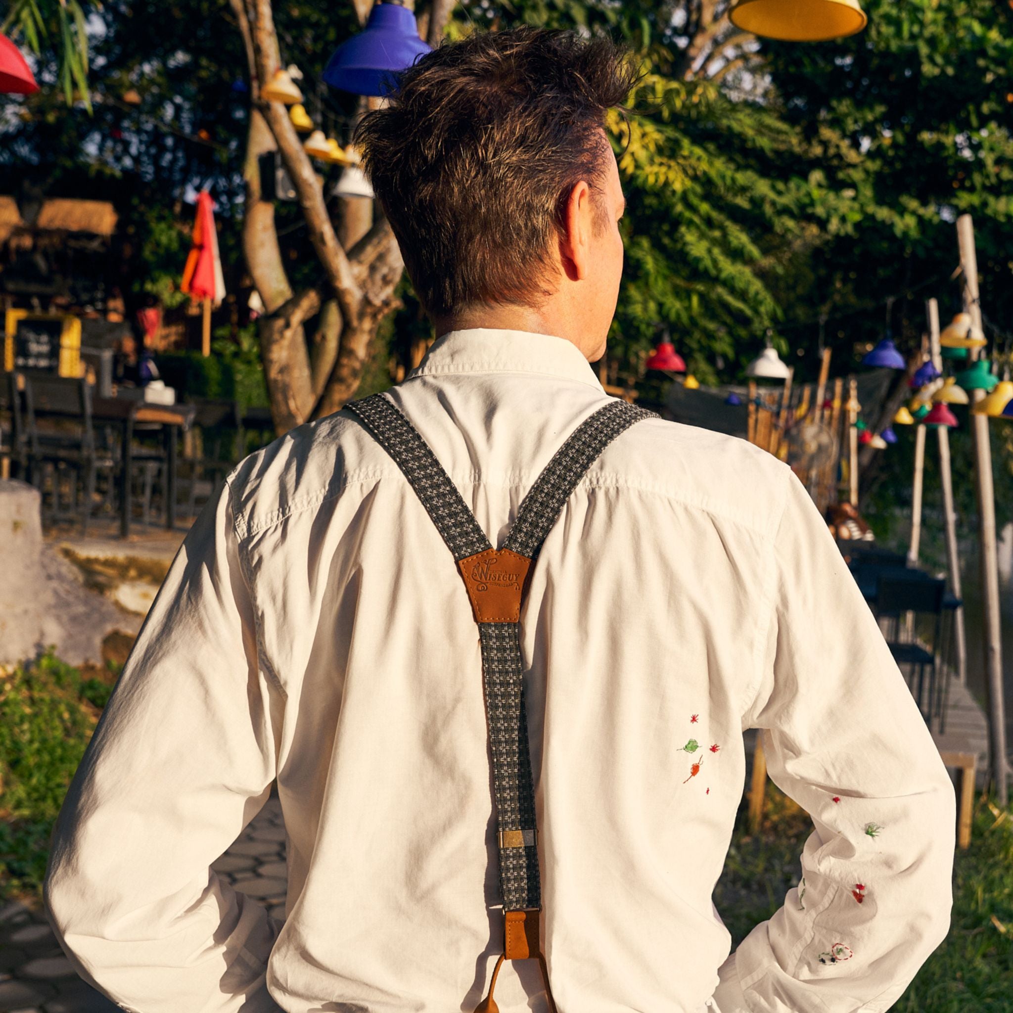 Back of man, he's wearing a white shirt and a pair of Wiseguy Original Suspenders with a pattern.